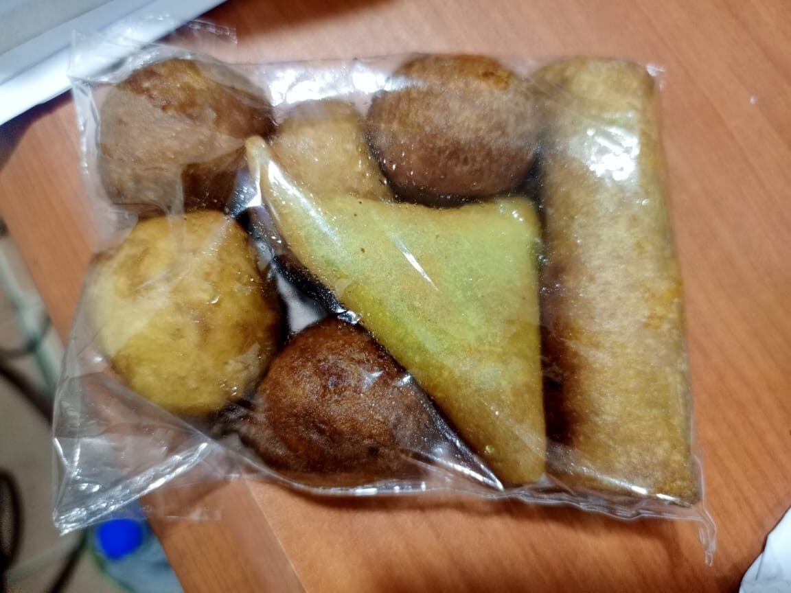 A pack of small chops that includes Samosa, spring roll and puff puff.