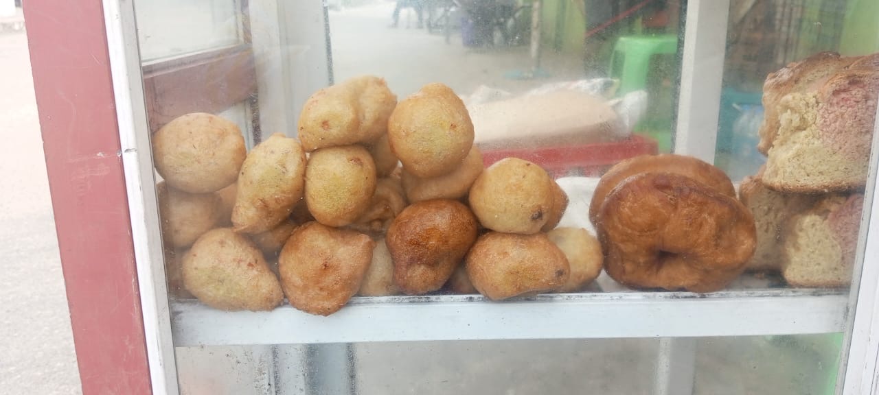 Puff puff neatly arranged in a glass casing.